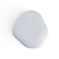 A droplet of Liberation Nails nail polish in a cool light gray color, Astrologic.