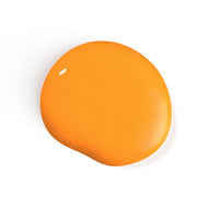 A droplet of Liberation Nails nail polish in an orangey yellow color, Goodyear.