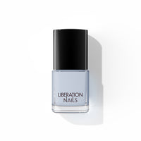 A bottle of Liberation Nails nail polish in a soft, cool gray color, Stormproof.