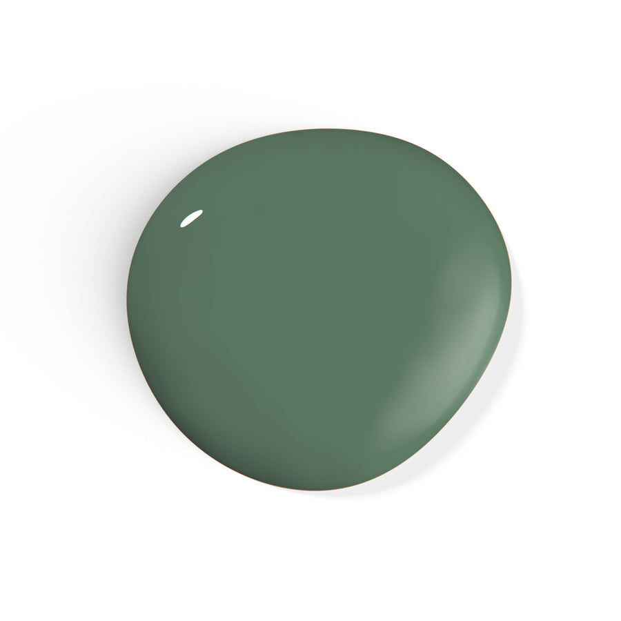 A droplet of Liberation Nails nail polish in a dark green color, Crowdfund