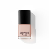 A bottle of Liberation Nails nail polish in a soft nude pink color, Darling.