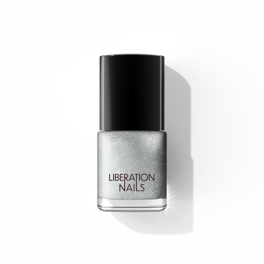 A bottle of Liberation Nails nail polish in a shimmery silver color, Disco Salvation. 