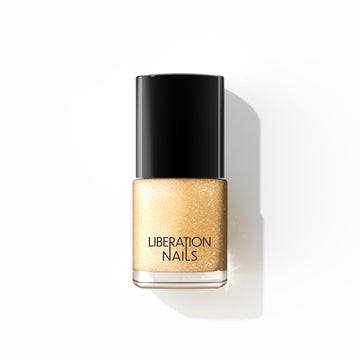 A bottle of Liberation Nails nail polish in a shimmery gold color, Gilded Mystic