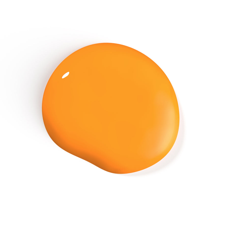 A droplet of Liberation Nails nail polish in an orangey yellow color, Goodyear.