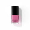 A bottle of Liberation Nails nail polish in a muted pink color, Joyful Heart.