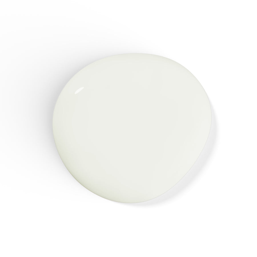 A droplet of Liberation Nails nail polish in a soft creamy white color, Light Worker.