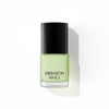 A bottle of Liberation Nails nail polish in a soft, light green color, Self Soothe.