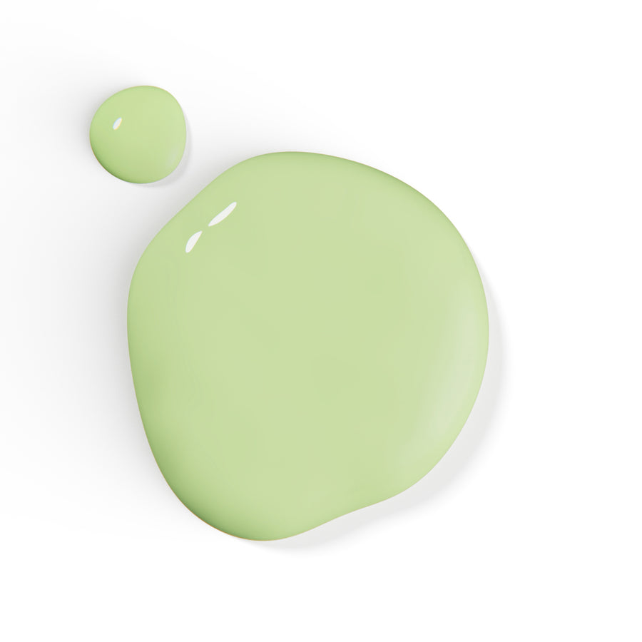 A droplet of Liberation Nails nail polish in a soft, light green color, Self Soothe.