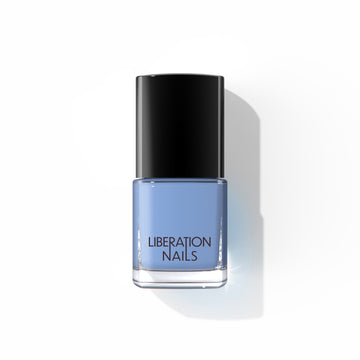 A bottle of Liberation Nails nail polish in a light blue color, Surrender.